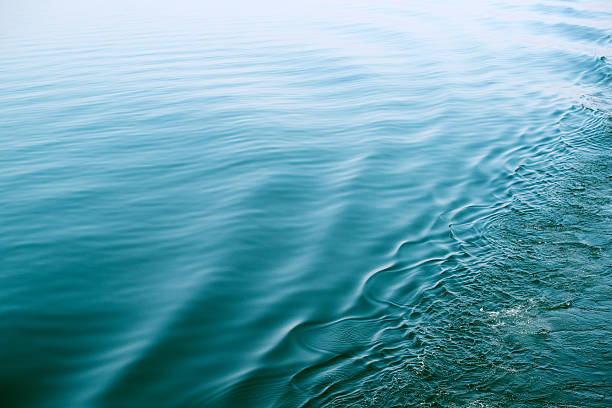 Calm surface of a lake with diagonal disturbance. stock photo