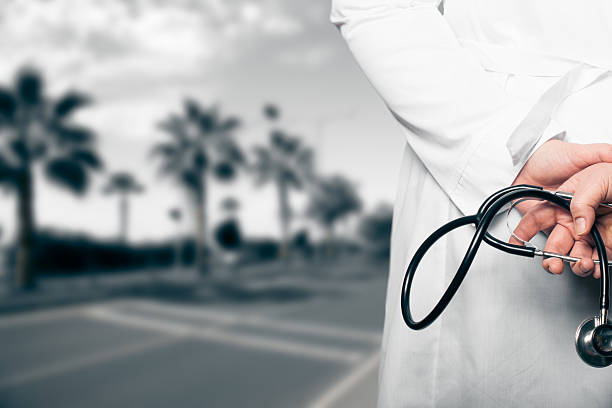 istock The doctor put his hands with stethoscope behind his back 614309690