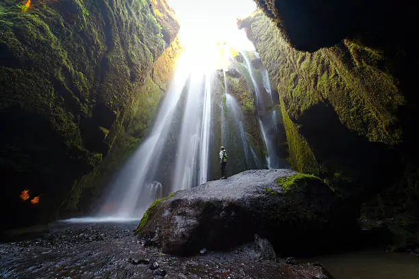 Photo of Woman admiring Gljúfrafoss waterfall