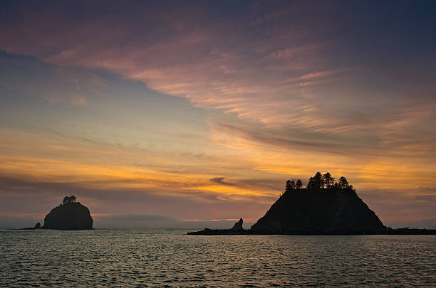 istock sunset over small islands in silhouette off the Washington coast 614312088