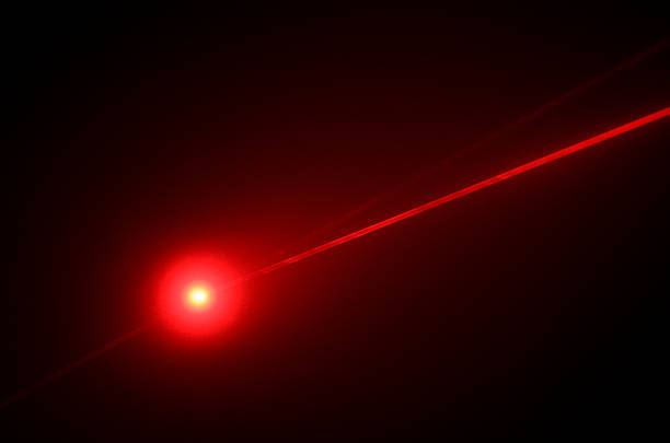 Red Laser Beam and Reflections A red laser beam focused on a reflective surface.  The beam is photographed passing though some haze. laser stock pictures, royalty-free photos & images