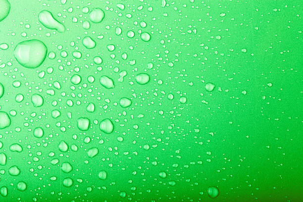 istock Drops of water on a color background. Green. Toned 614313444