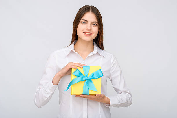 istock Young woman portrait holding gift 614314318