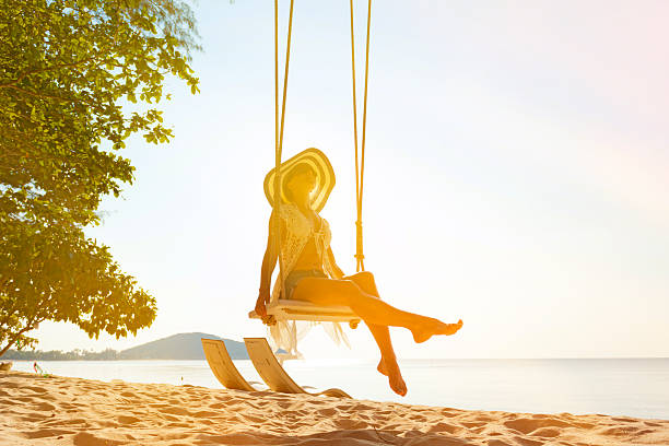 istock Woman at tropical swing 614317626