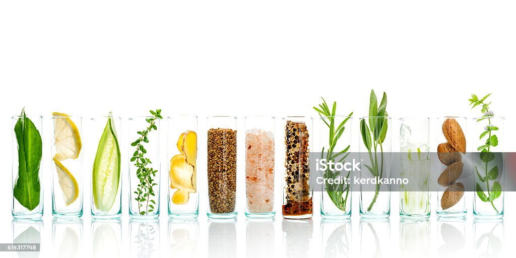 Homemade skin care and body scrubs with natural ingredients. Homemade skin care and body scrubs with natural ingredients aloe vera ,lemon,cucumber ,himalayan salt ,peppermint ,lemon slice,rosemary,almonds,cucumber,ginger and honey pollen isolate on white background. Beauty Product Stock Photo