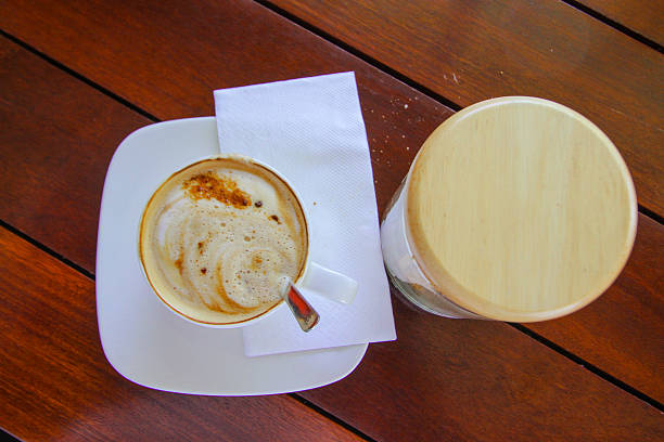 istock cup of coffee on wooden table, Top view a cup 614318132