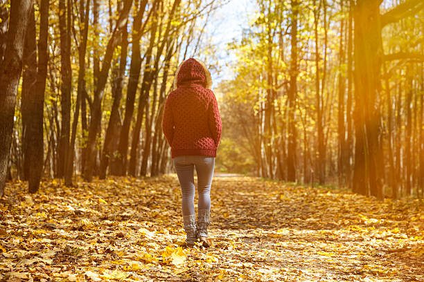 istock Woman in autumn park 614319338