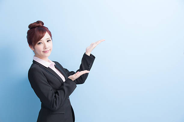 istock business woman show something 614320176