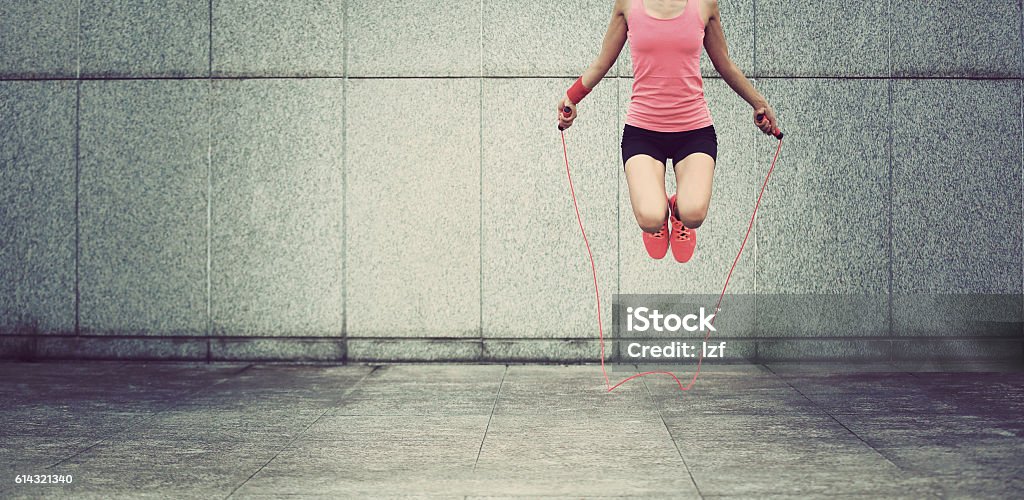 young fitness woman jumping rope outdoor Jump Rope Stock Photo
