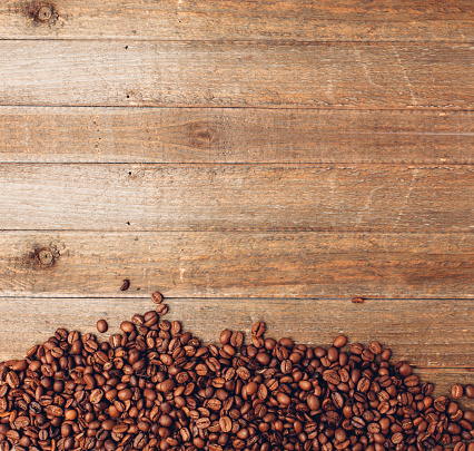 Coffee bean background on a wooden table.