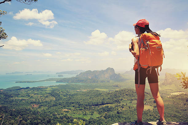 istock successful woman hiker  enjoy the view at mountain peak 614322738