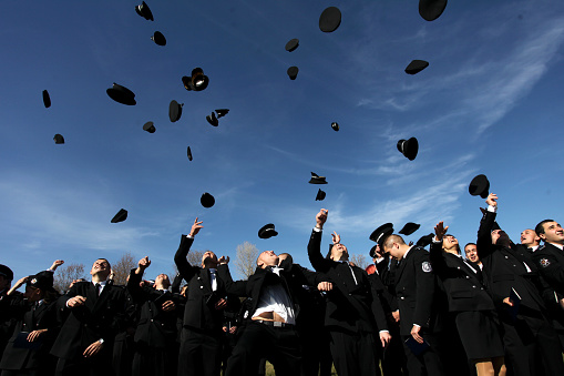 Sofia, Bulgaria - October 30, 2013: Cadets of the Police Academy in  throwing their hats in the air .