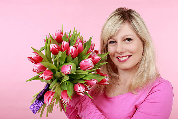 istock Pretty woman with tulips 614330490