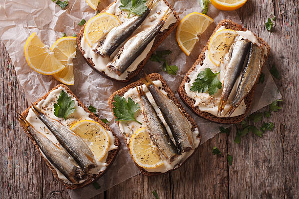 istock Sandwiches with sprats, cream cheese close-up. Horizontal top view 614331310
