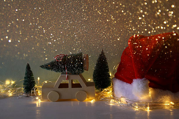 istock Low key image of wooden car carrying a christmas tree 614331646