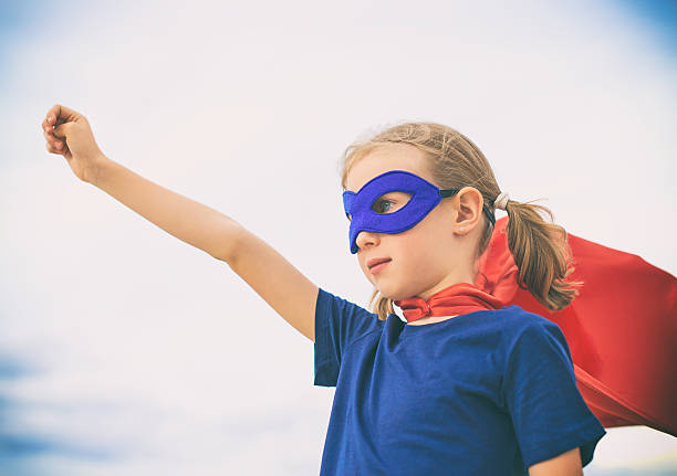 istock Superhero kid against blue sky background. 614332160