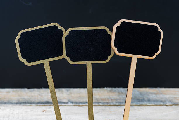 istock Wooden mini blackboard labels over chalkboard background 614332462