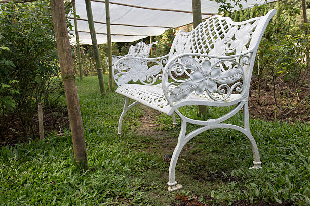 istock Beautiful white chairs in rose garden 614332962