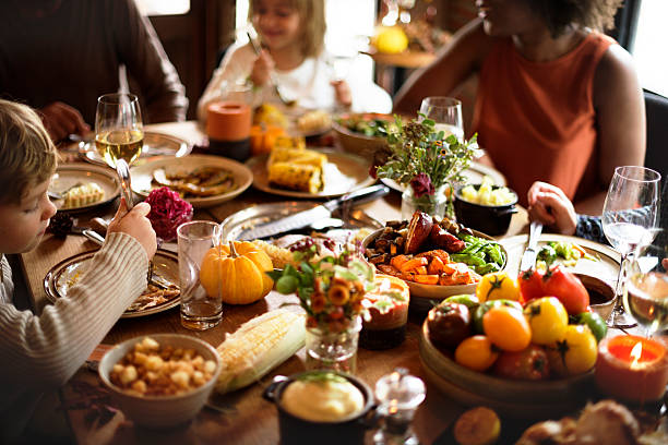 istock Children Eating Turkey Thanksgiving Celebration Concept 614333736