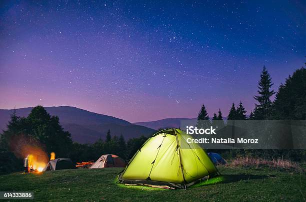 Illuminated Green Tent Under Stars At Night Forest Stock Photo - Download Image Now