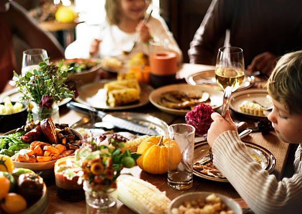 istock Children Eating Turkey Thanksgiving Celebration Concept 614333930