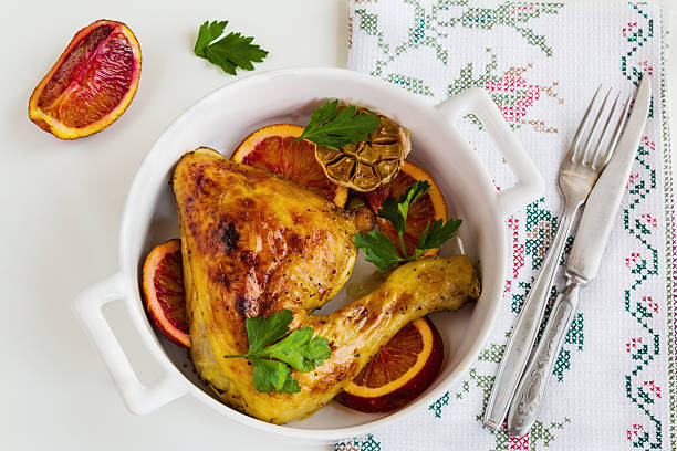 istock Roasted chicken legs, red oranges, garlic and parsley 614334588