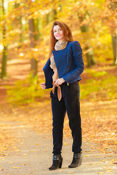 istock Fashionable young woman in forest. 614335376