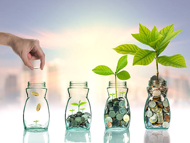 istock Hand putting mix coins and seed in clear bottle 614335604