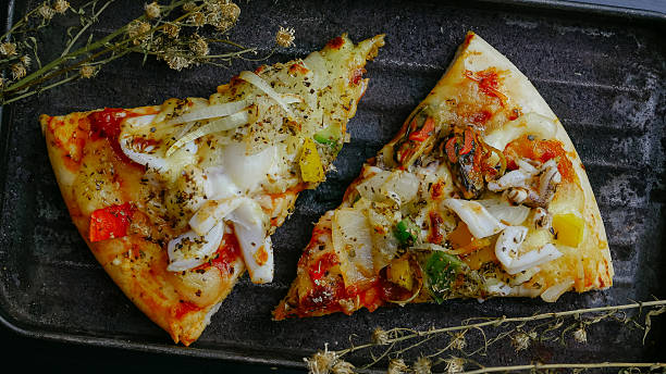 istock Fresh tasty pizza on black woodden table 614336562