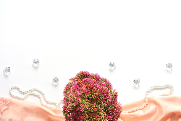 istock Mock up with flowers on white silk 614337676