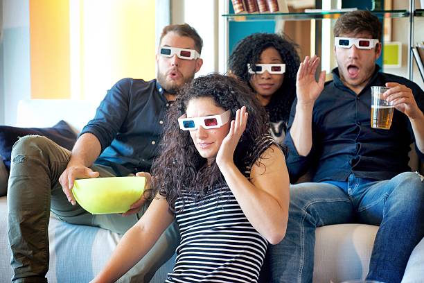 istock 4 People Watching Tv with 3D Glasses 614338872