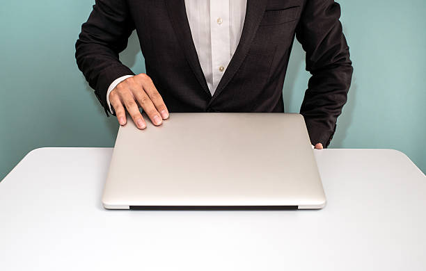 Businessman holding laptop.