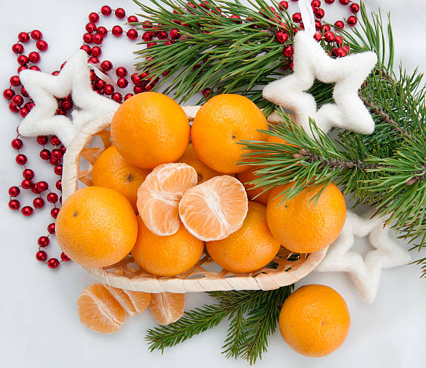 istock New year decoration with mandarins and fir tree 614338890