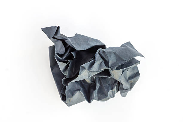 istock Crumpled black paper ball on a white background. 614340096