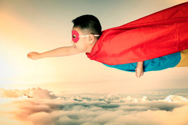 Asian Chinese boy wearing super hero costume in isolated white background.