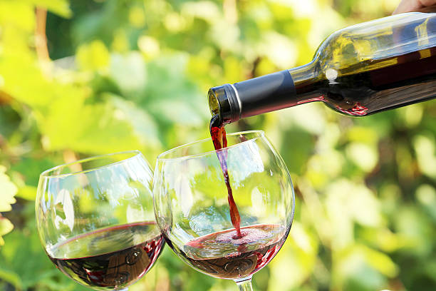 istock Pouring red wine into the glass 614340830