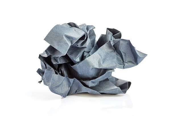istock Crumpled black paper ball on a white background. 614341400