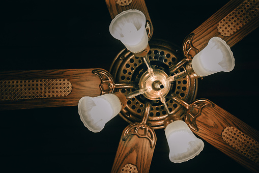 Ceiling fan with lights. Decorative ventilation with lamps on the ceiling. soft focus