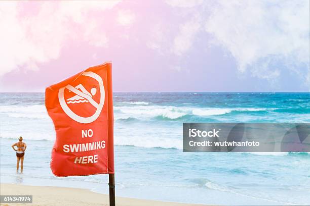 No Swimming Danger Sign At The Beach Stock Photo - Download Image Now - Beach, Blue, Breaking Wave