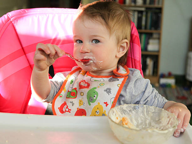 istock Babby girl eats healthy food 614342382