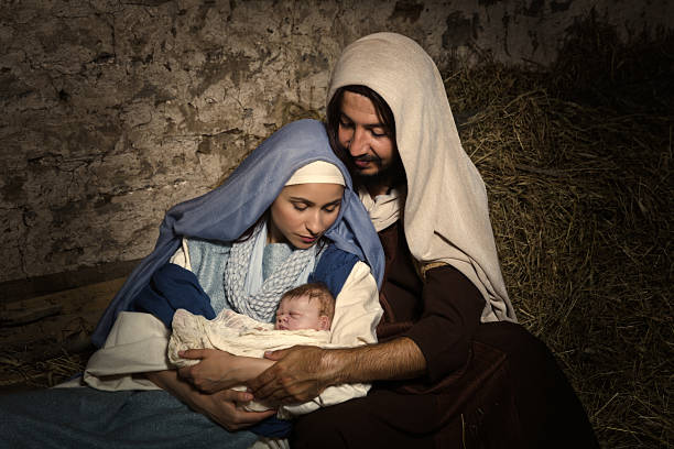 Baby Jesus in nativity scene Live Christmas nativity scene in an old barn - Reenactment play with authentic costumes.  The baby is a (property released) doll. virgin mary stock pictures, royalty-free photos & images