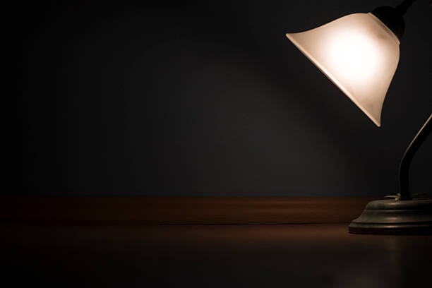 istock Old lamp with glowing light on wooden floor 614342822