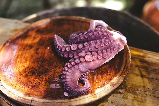 istock Wooden plate of galician cooked octopus 614343100