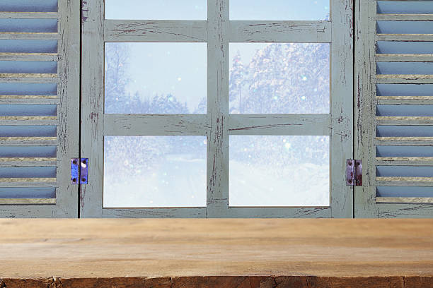 istock window sill in front of dreamy winter landscape background 614343920
