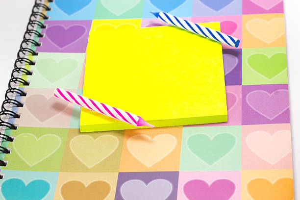 istock Happy birthday candle and blank notepad with love diary 614344086