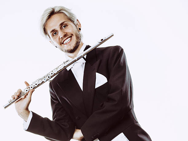 istock Male flutist wearing tailcoat holds flute 614344486