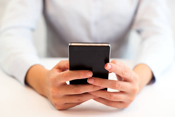 istock Hand holding smart phone 614345056