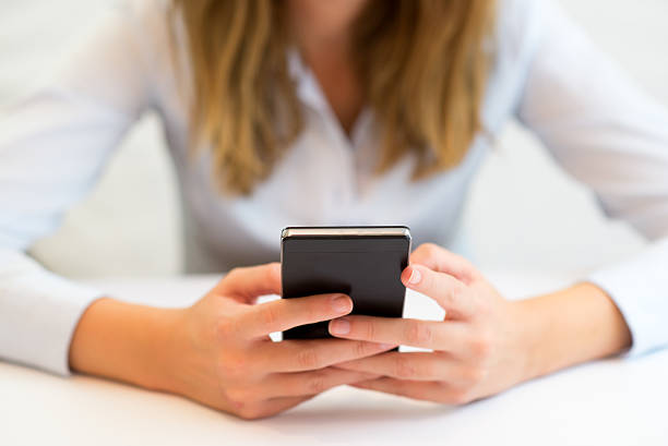 istock Woman typing on mobile phone 614345172
