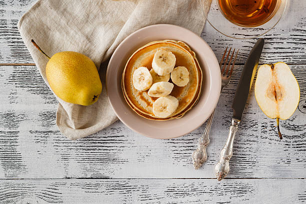 istock Stack of pancakes on vintage white wooden background 614345794