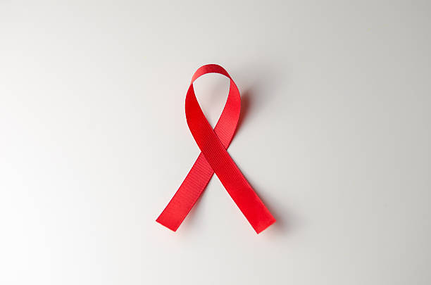 istock Red ribbon HIV, AIDS on gray background. 614346000